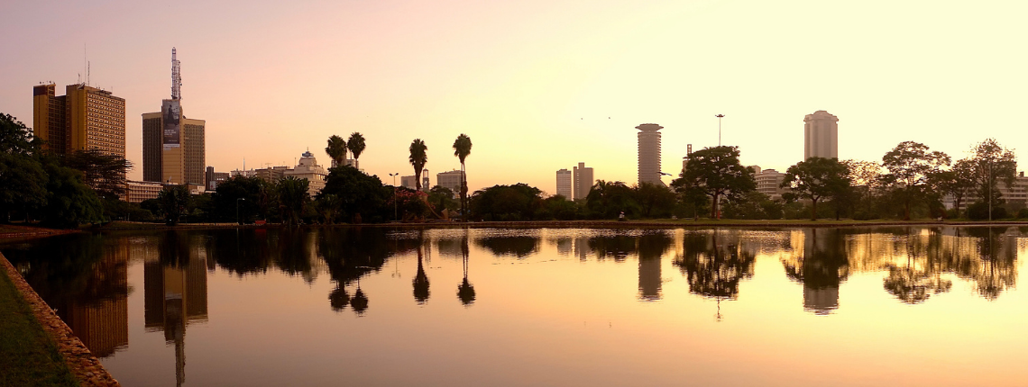 Nairobi skyline at sunset reflected in water